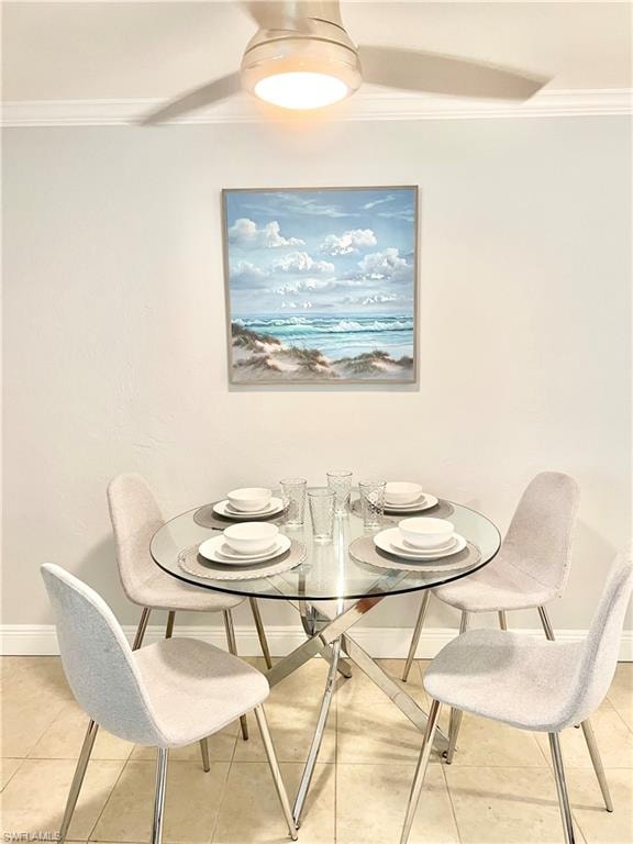 Crown molding, ceiling fan with integrated lighting, tile flooring, and a glass-top dining table with a polished metal base