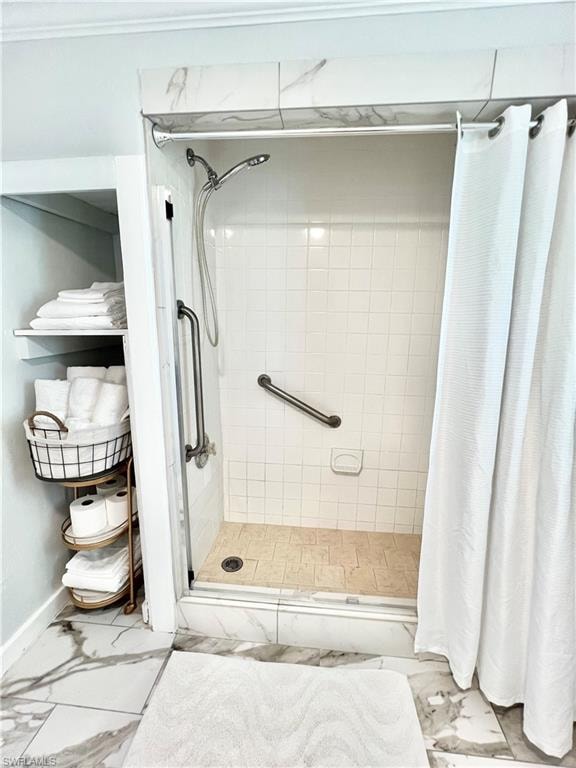 Walk-in shower with a glass enclosure, white square tile walls, and a tiled shower floor