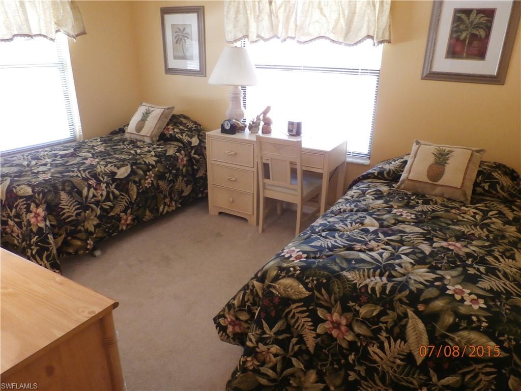 Bedroom with carpet flooring and multiple windows