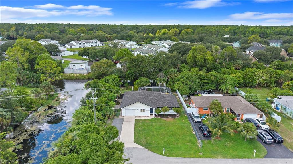 Single-story residence featuring an attached garage, paved driveway, and established landscaping