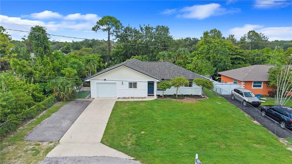 Single-story residence featuring a gray shingle roof, attached garage, and a concrete driveway