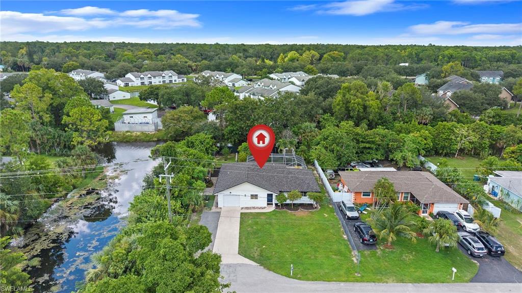 Single-story residence with an attached garage, a paved driveway, and a manicured front lawn
