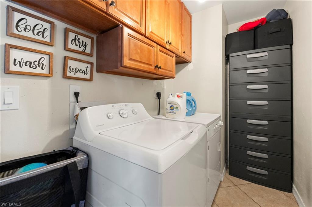 Built-in wood-finish cabinetry, tile flooring, and dedicated appliance space