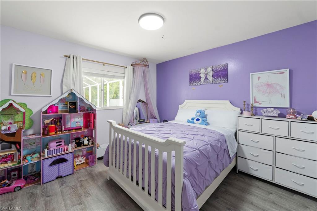 Recessed lighting, wood-finish flooring, and window with blinds