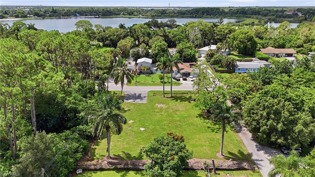 Expansive green space with mature trees, established roadways, and water frontage