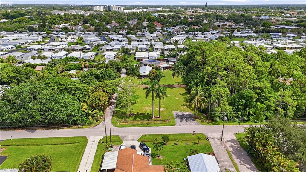 Expansive lot with mature trees and paved road frontage