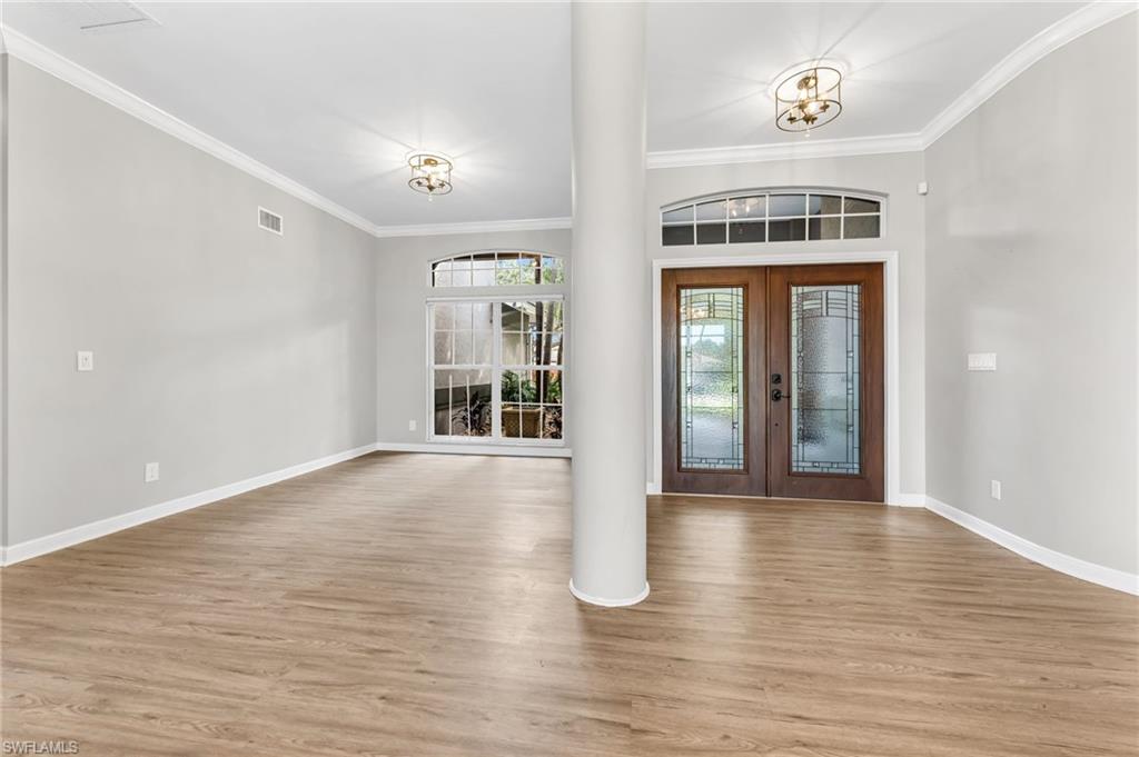 Wood-finish flooring throughout, complemented by crown molding and recessed lighting