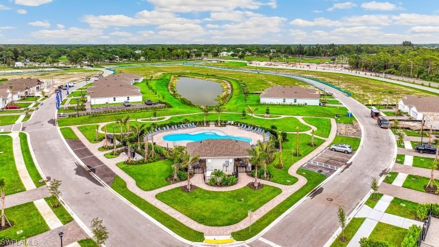 Community amenities featuring a central pool area with lounge chairs, a covered pavilion, and surrounding green spaces with mature palm trees