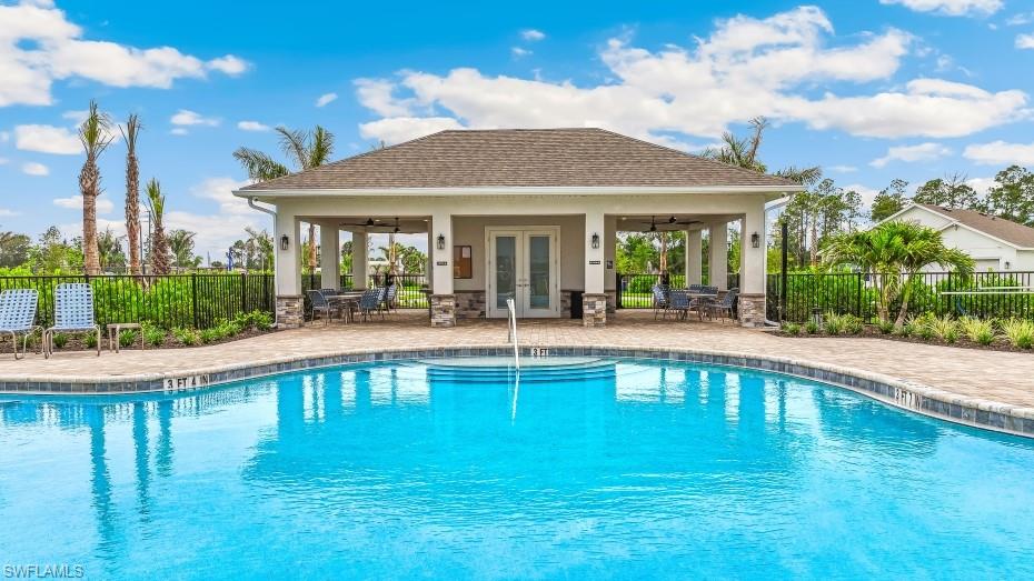 The community features an outdoor swimming pool with an integrated spa, a paver deck, and a covered pavilion with outdoor seating
