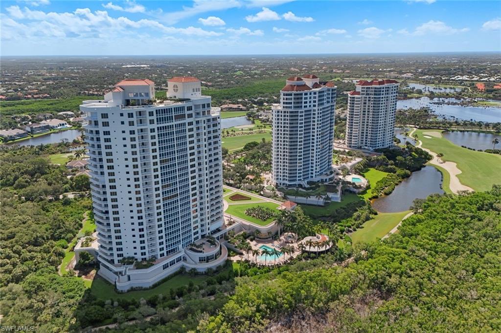 Aerial view showcasing a collection of modern high-rise residential towers nestled within lush landscaping and mature greenery