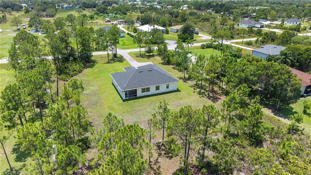 Modern home situated on expansive wooded grounds featuring mature pine and hardwood trees