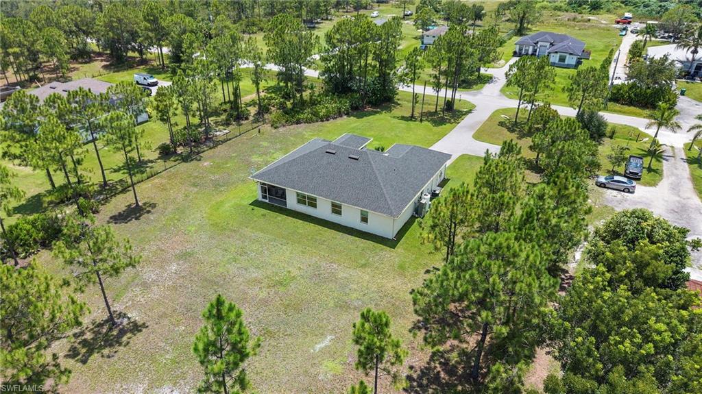 Modern single-story home situated on expansive grounds featuring mature pine and hardwood trees