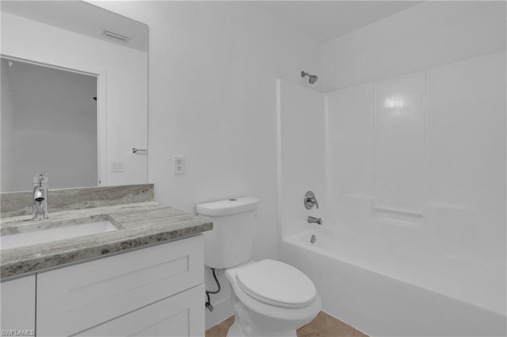 White vanity with a neutral-toned countertop and an integrated sink, polished chrome faucet, and full-width mirror