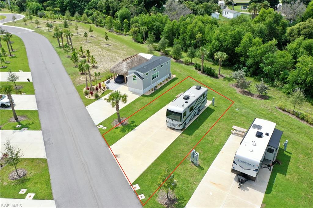 Paved RV pad with green lawn surround