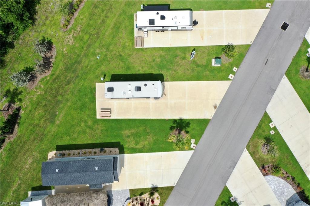 Paved roadway with multiple concrete pads, each featuring an adjacent green space