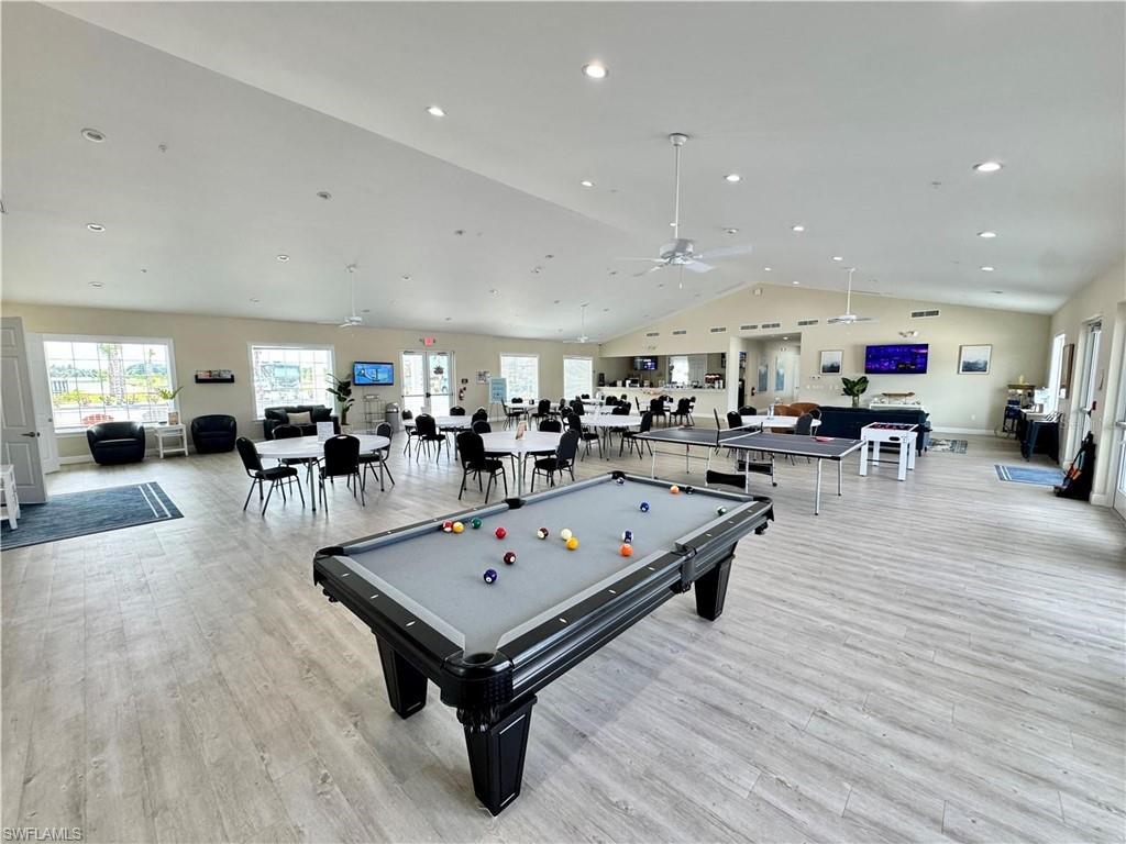 Spacious common area featuring vaulted ceilings, wood-finish flooring, recessed lighting, and ceiling fans