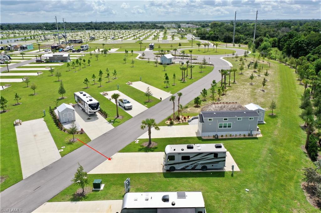 Expansive green spaces with paved roadways, individual concrete pads, and varied landscaping