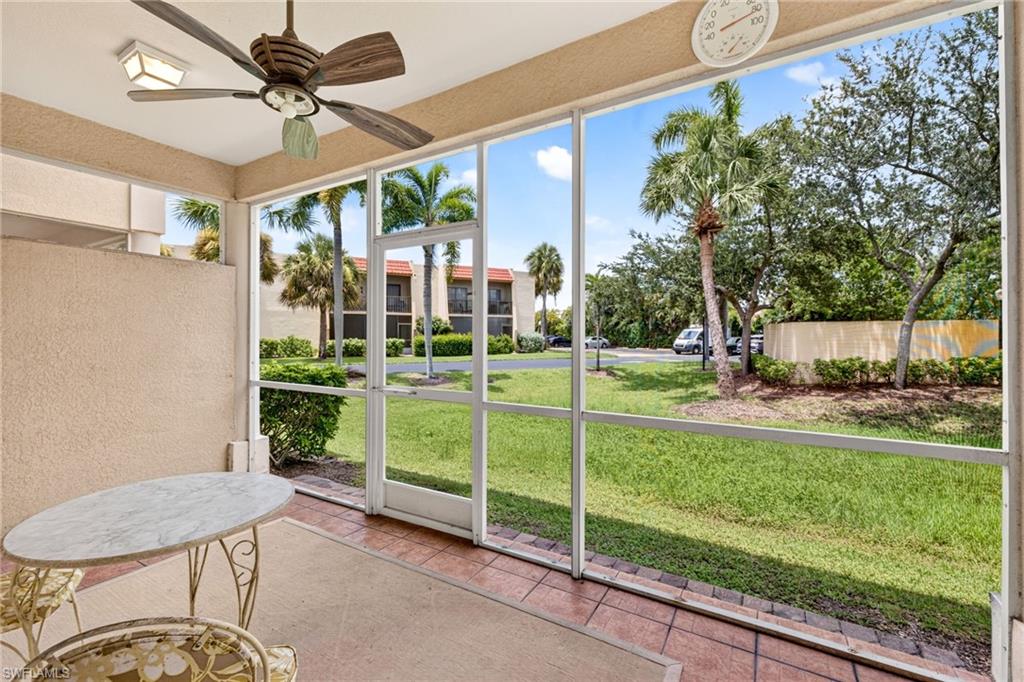 Screened patio with a wood-finish ceiling fan and tiled flooring