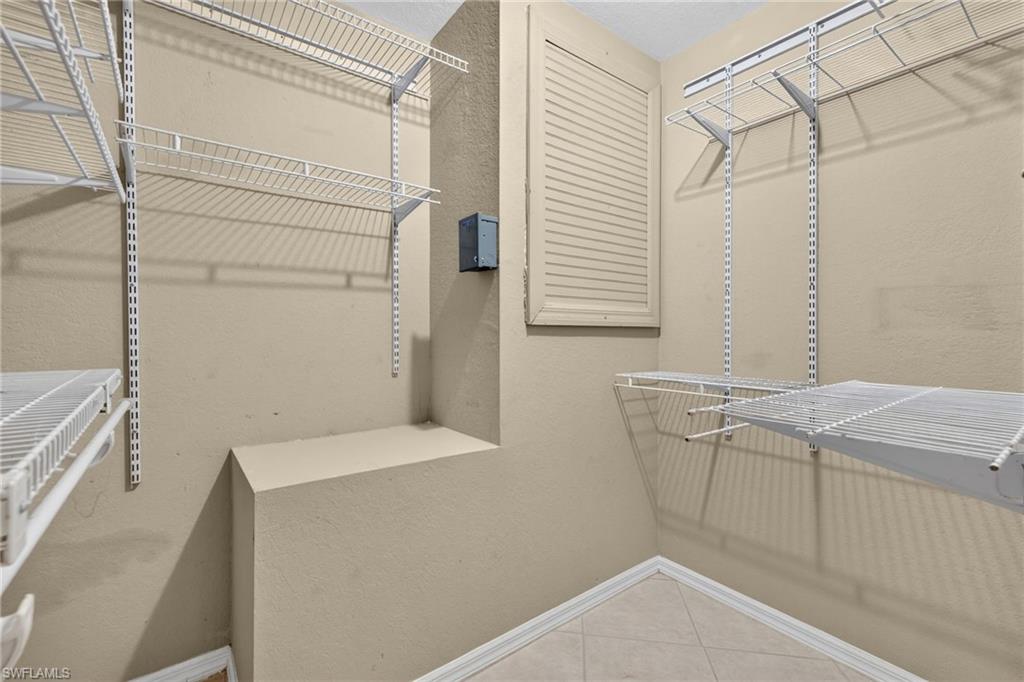 Wire shelving systems, built-in shelving, louvered vent, and neutral-toned walls