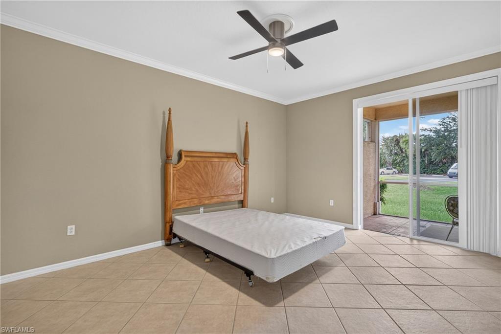 Tile flooring, crown molding, modern ceiling fan with integrated lighting, and sliding glass door leading to an outdoor patio