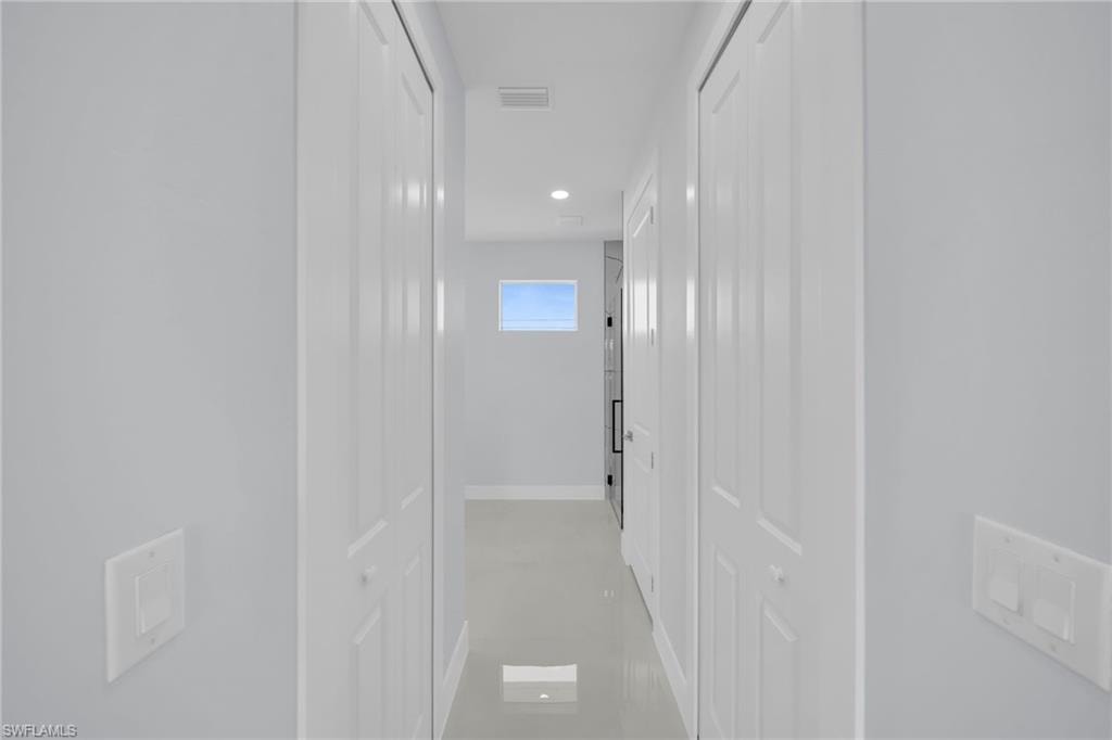 Hallway featuring a built-in window and recessed lighting