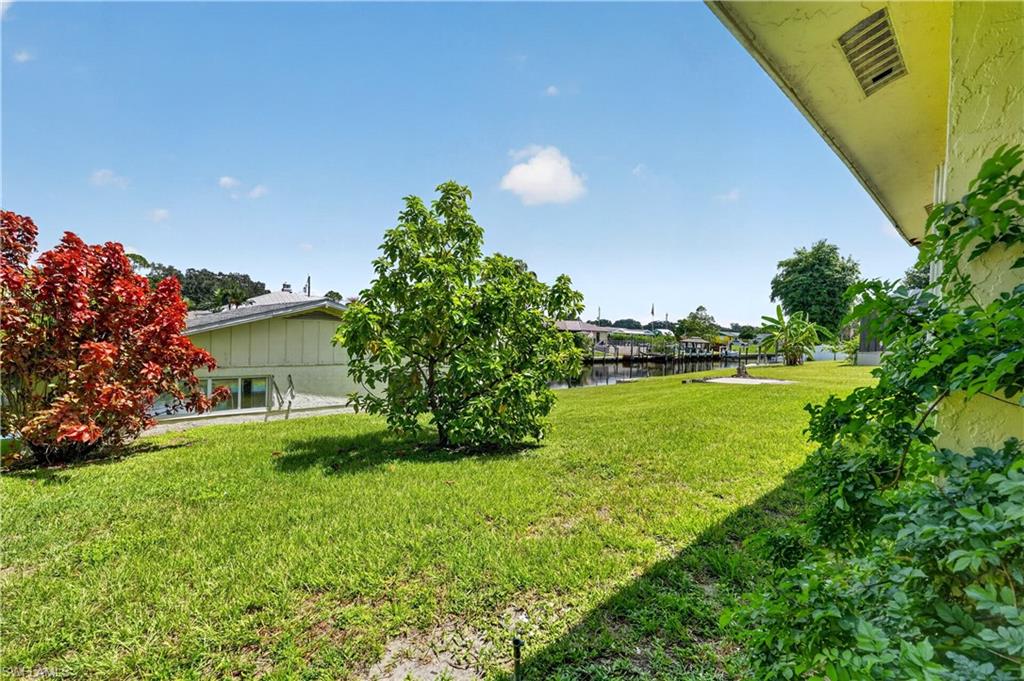 Expansive green space featuring mature trees and a manicured lawn