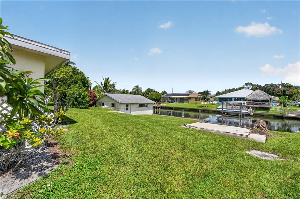 Expansive green lawn with water frontage and canal access