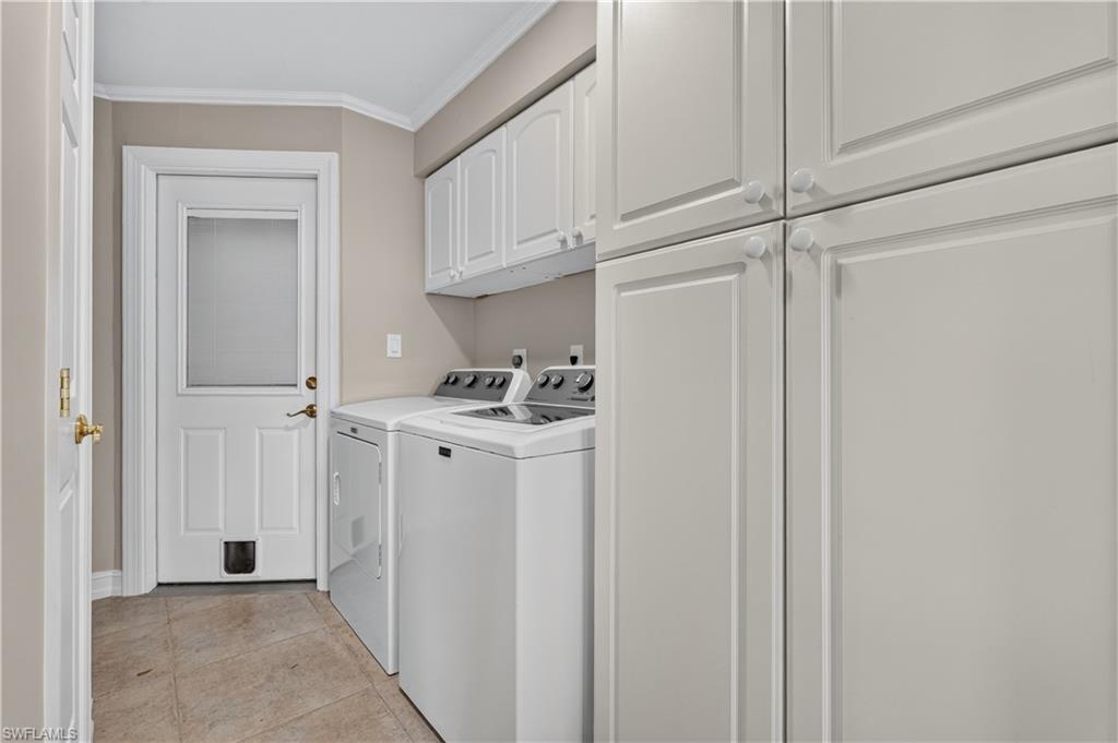 Laundry area featuring tile flooring, white cabinetry, a built-in washing machine, and a built-in dryer