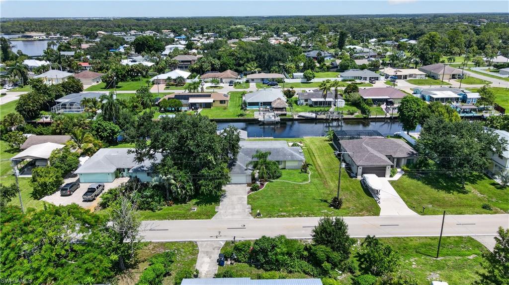 Waterfront property with canal access, private boat dock, and lush mature landscaping