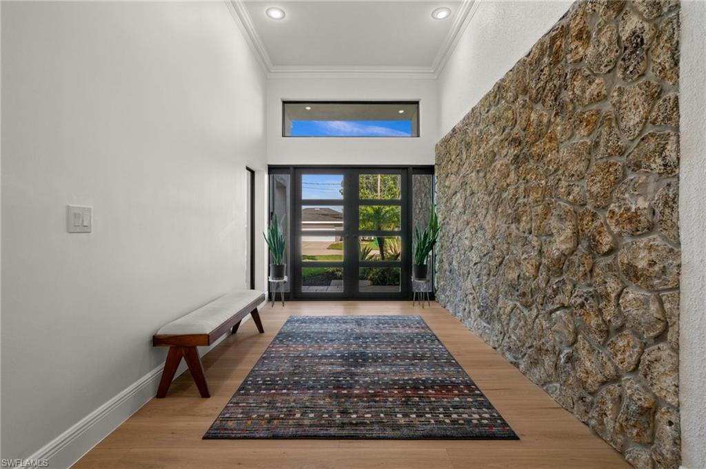 The Foyer with custom front doors and natural stone wall