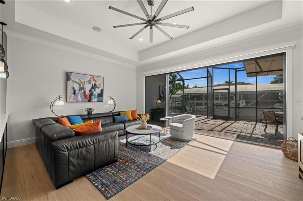 Family Room with full wall of stacking sliding doors overlooking the pool and water