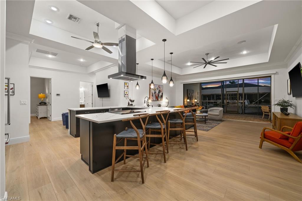 Evening view of the kitchen, family room and pool