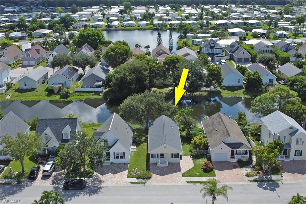 Aerial view showcasing this residence nestled on a tree-lined street within an established neighborhood