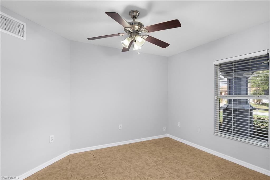Bright corner bedroom with neutral wall finishes, wood-finish flooring, and abundant natural light from large windows