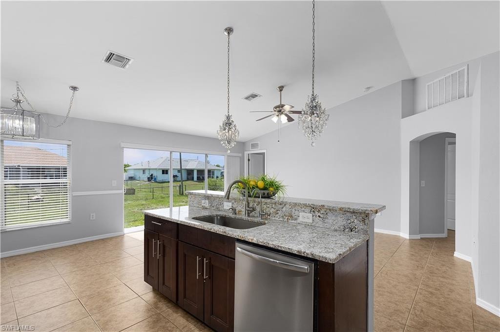 Kitchen island with undermount sink, stainless steel dishwasher, and stone-finish countertop