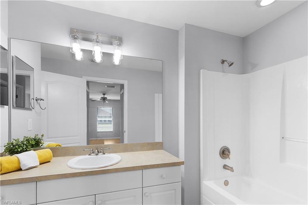 Single vanity with a white basin and light-toned countertop