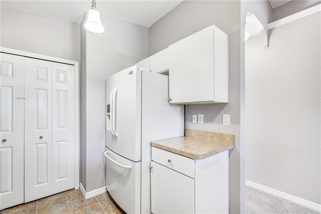 Kitchen fridge and white cabinets