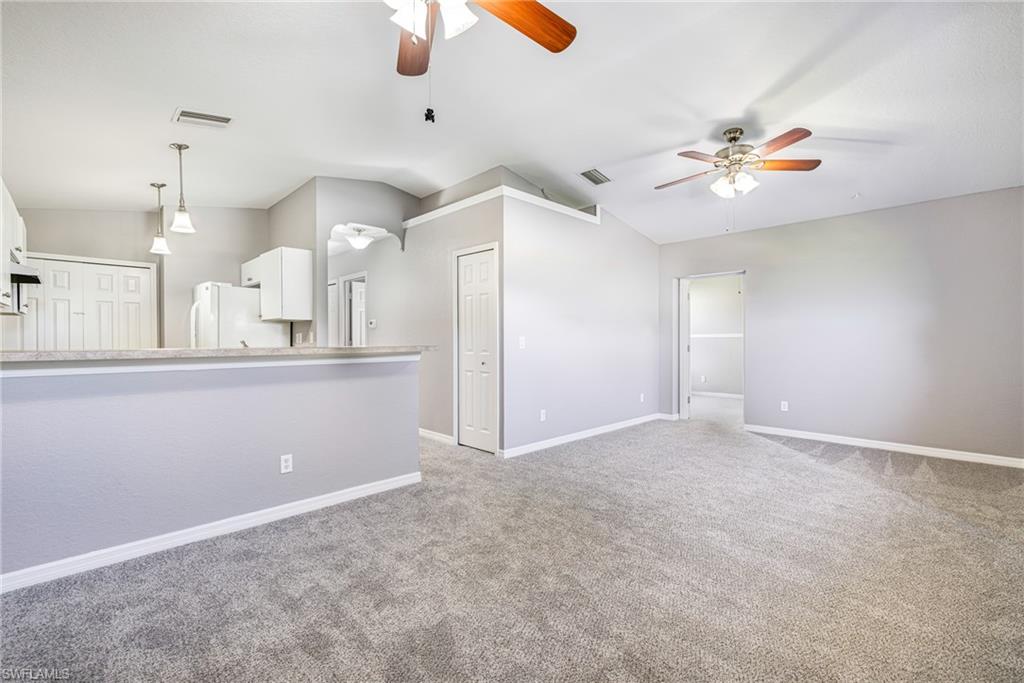Living room showcasing the high ceilings and updated lighting