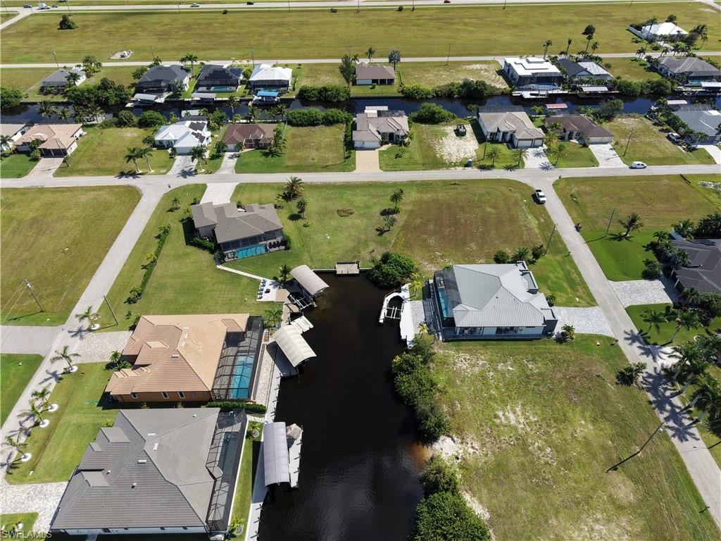 Waterfront Lot with Private Dock and BoathouseExpansive waterfront property featuring a private residential dock with boat lift and covered boathouse structure