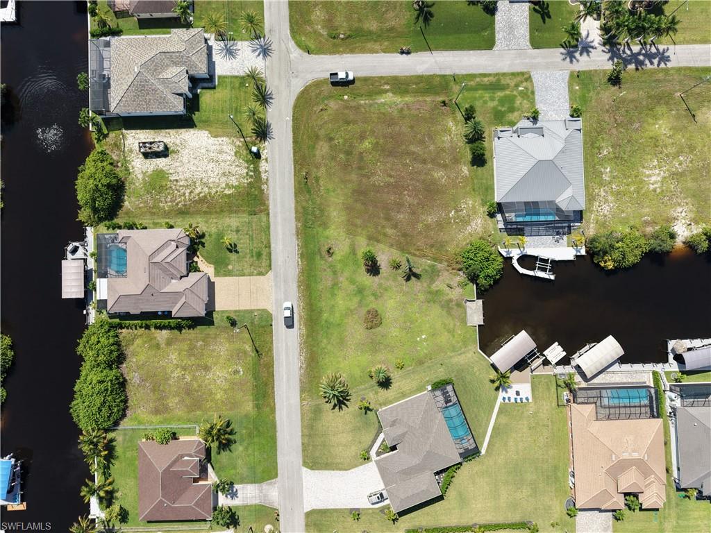 Waterfront lot featuring mature landscaping, expansive lawn, and direct water access
