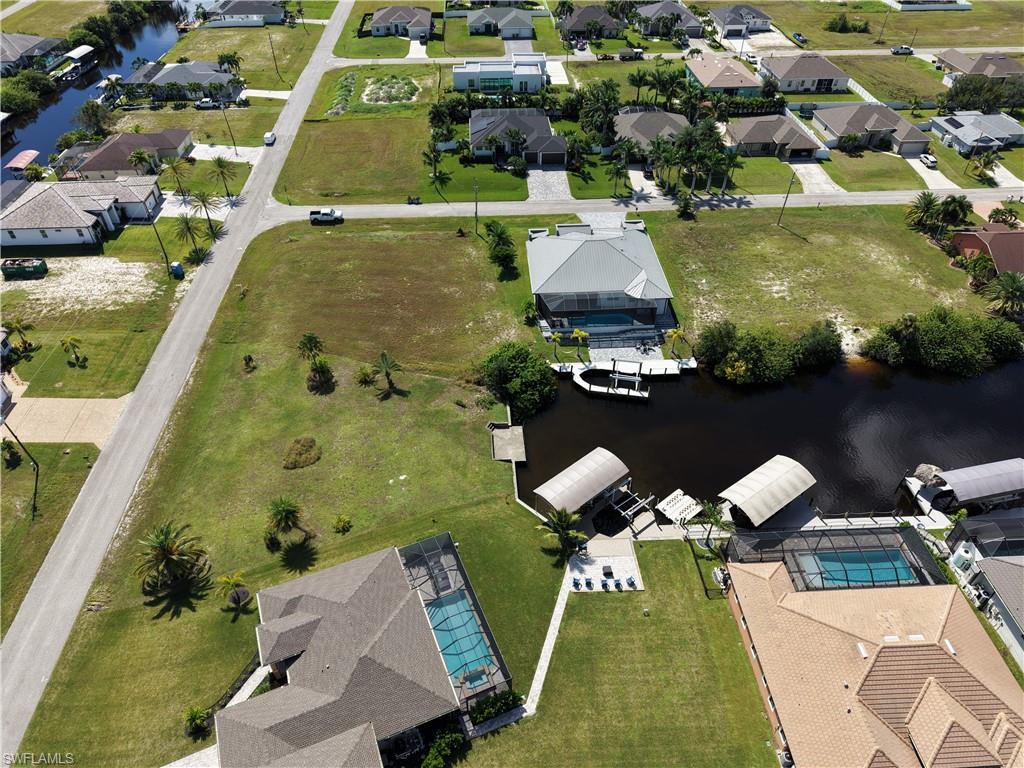 Canal-front property featuring a private boat dock and covered boat lift