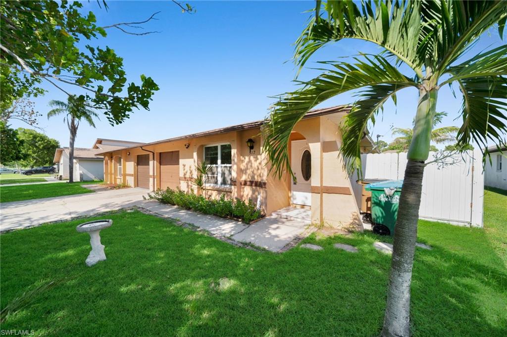 Charming single-story residence with warm terracotta exterior and broad covered entry portico