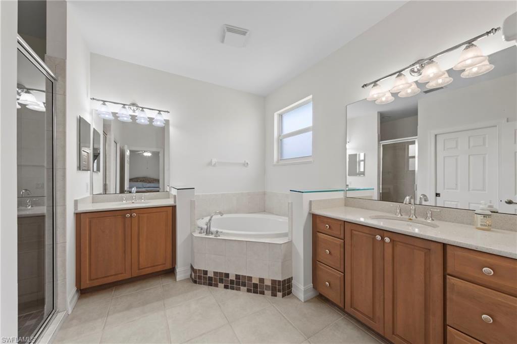 Dual vanities with undermount sinks and light-toned countertops