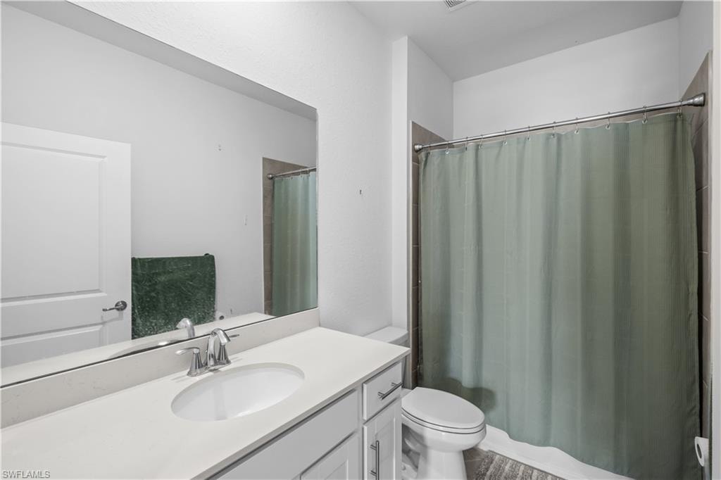 Second Bathroom White vanity with an integrated sink and chrome faucet
