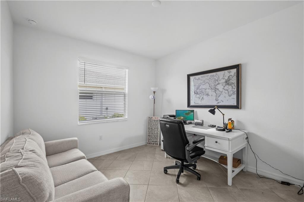 Neutral-toned tile flooring, white painted walls, and a window with horizontal blinds