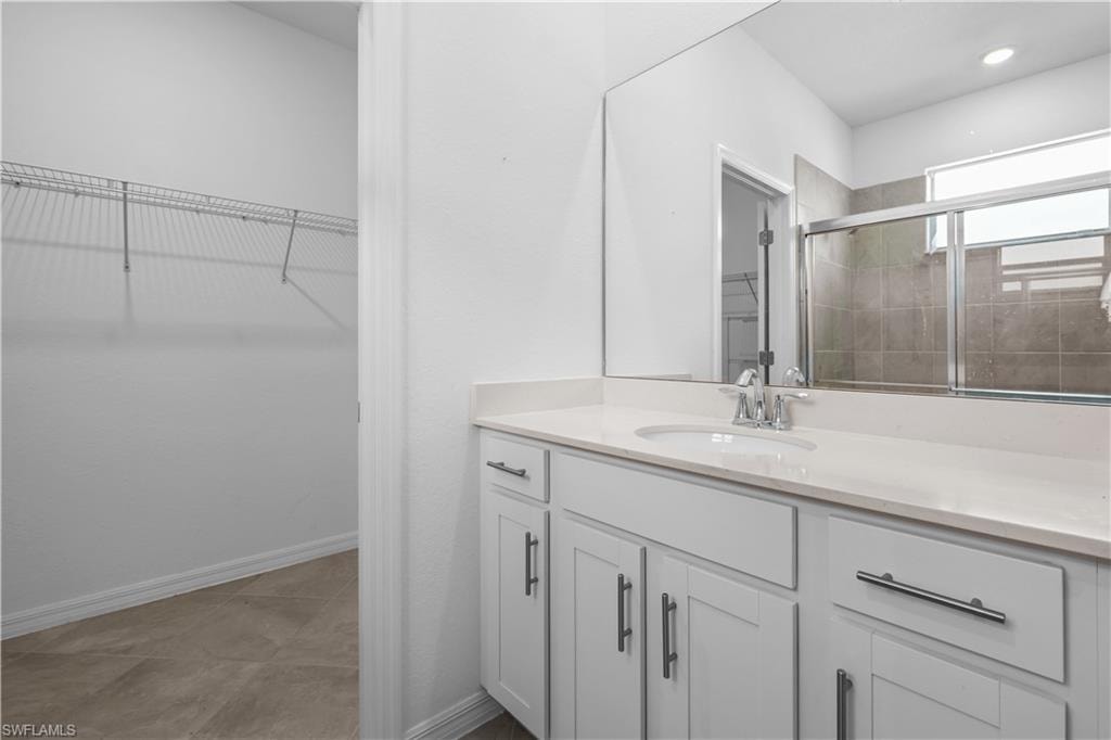 Master BathroomWhite double vanity with brushed nickel hardware, integrated sink, and a light-toned countertop