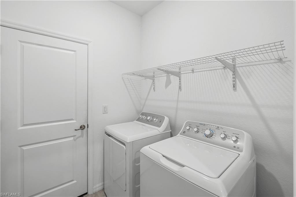 Built-in wire shelving provides storage above the laundry appliances