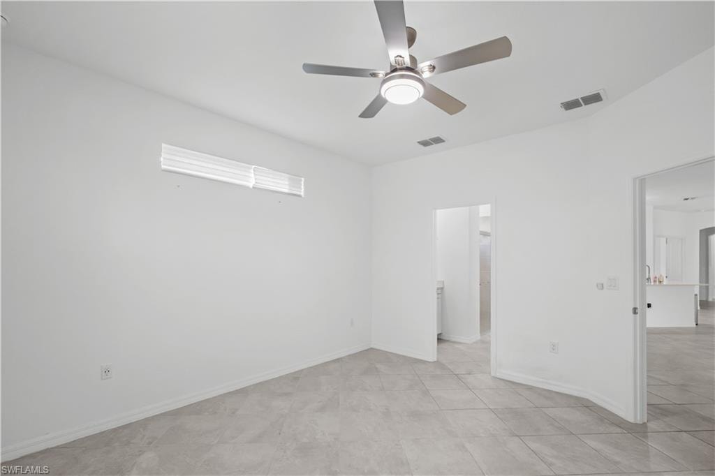 Master Bedroom continuationRecessed window, ceiling fan with integrated lighting, tile flooring, and a neutral color palette