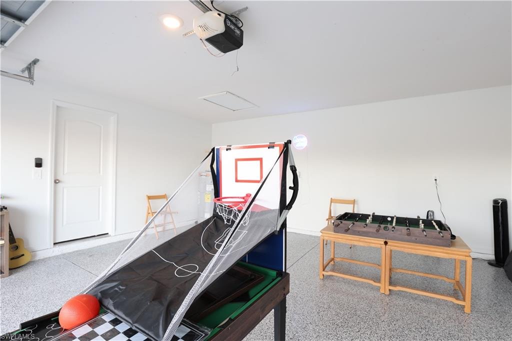 Finished garage space with an epoxy floor, a white interior door, and an automatic garage door opener