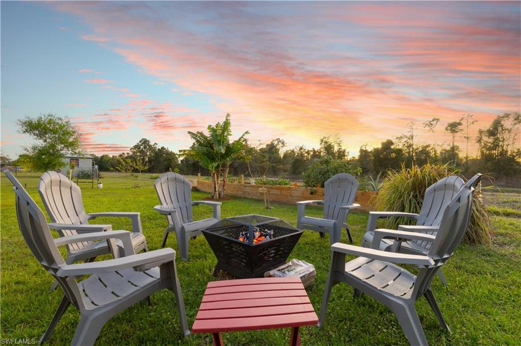 Expansive grass lawn featuring a fire pit